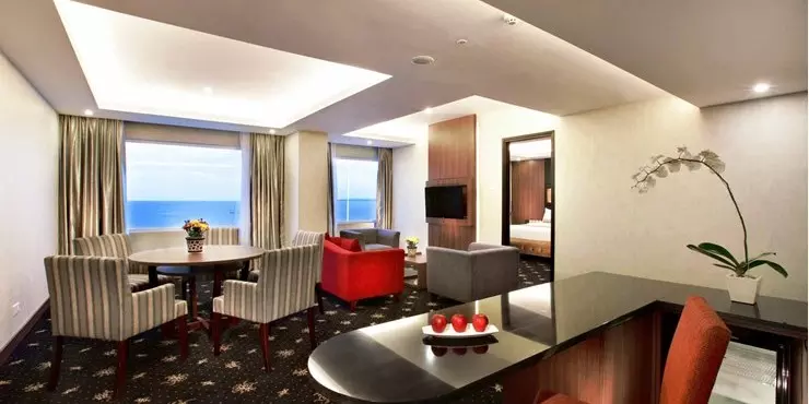 Spacious suite with ocean view adjoined living and dining area in a modern hotel in kupang