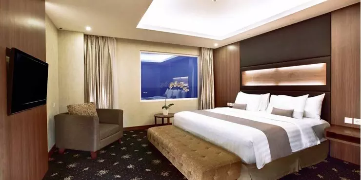 Spacious suite with ocean view adjoined living and dining area in a modern hotel in kupang
