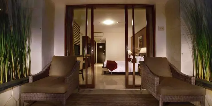 Spacious private balcony overviewing the pool or garden in modern luxurious hotel in kuta bali