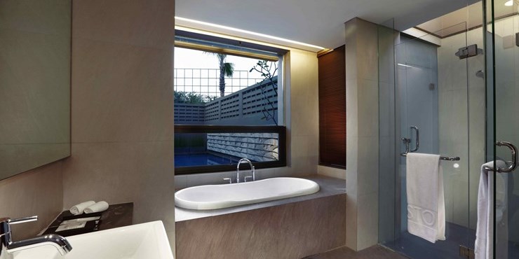 Exclusive private bathroom with rain shower and porcelain bath tub available while staying in the best hotel surrounded by mountain view in Sentul area